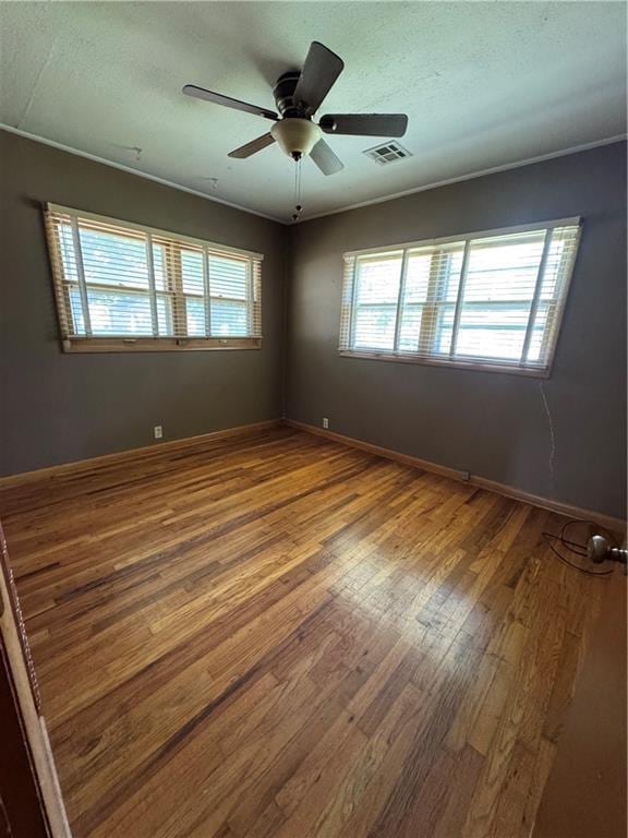 915 W 4th St, Chanute, KS 66720 - empty room featuring wood finished floors and a ceiling fan