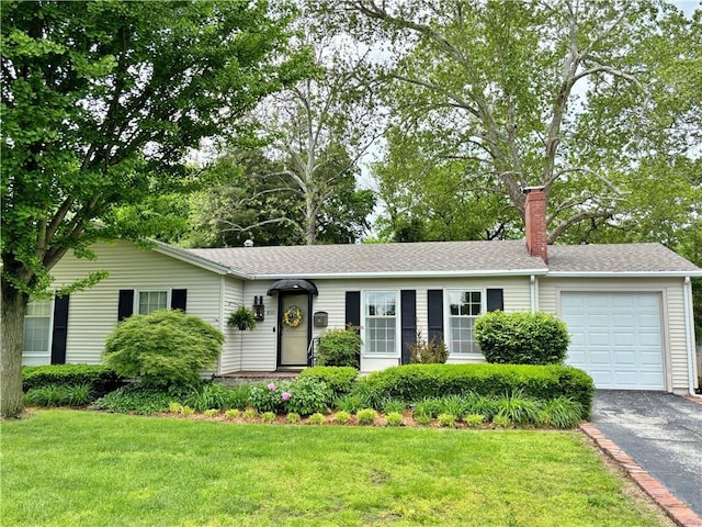 610 S Woodland St, Pittsburg, KS 66762 - ranch-style house with asphalt driveway, an attached garage, a chimney, and a front yard