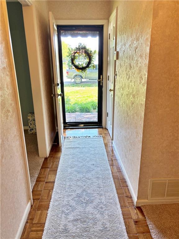 610 S Woodland St, Pittsburg, KS 66762 - doorway with a textured wall and plenty of natural light