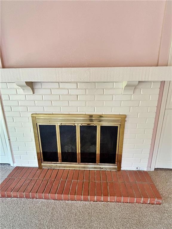 610 S Woodland St, Pittsburg, KS 66762 - detailed view of a fireplace and carpet flooring