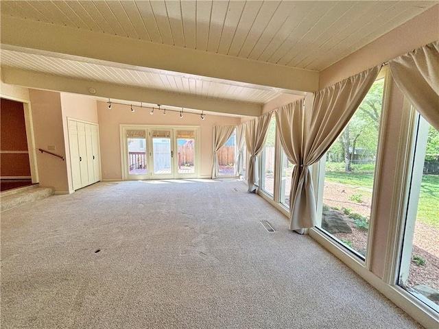 610 S Woodland St, Pittsburg, KS 66762 - unfurnished living room featuring carpet floors, beamed ceiling, wooden ceiling, and track lighting