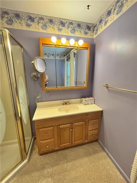 610 S Woodland St, Pittsburg, KS 66762 - bathroom with a shower stall, vanity, baseboards, and carpet