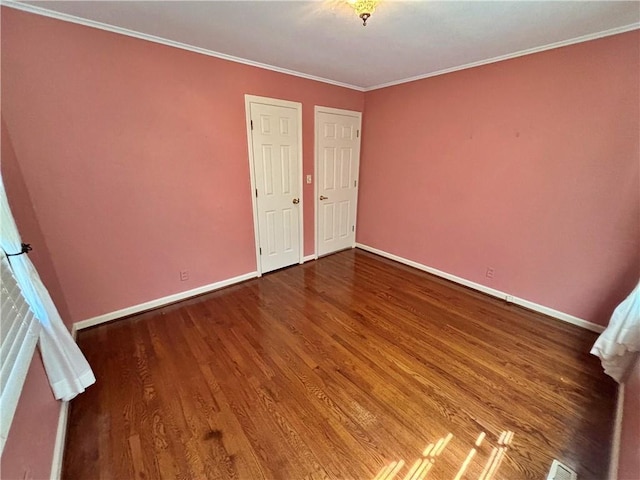 610 S Woodland St, Pittsburg, KS 66762 - unfurnished bedroom featuring wood finished floors, baseboards, and ornamental molding