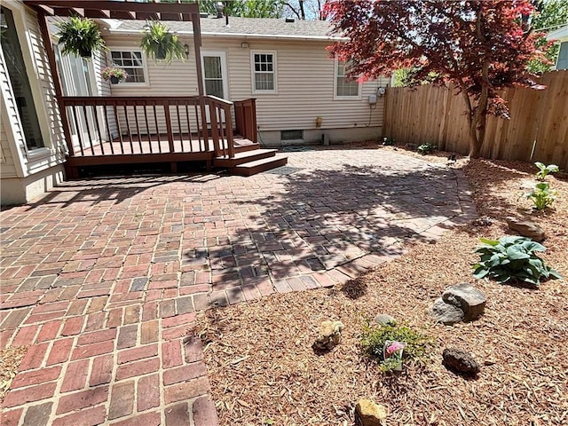 610 S Woodland St, Pittsburg, KS 66762 - back of property with fence, a wooden deck, a patio area, and crawl space