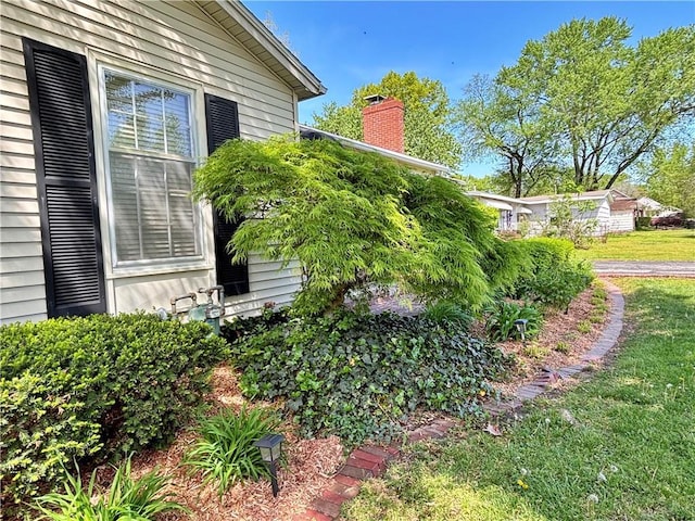 610 S Woodland St, Pittsburg, KS 66762 - view of home's exterior with a chimney and a yard