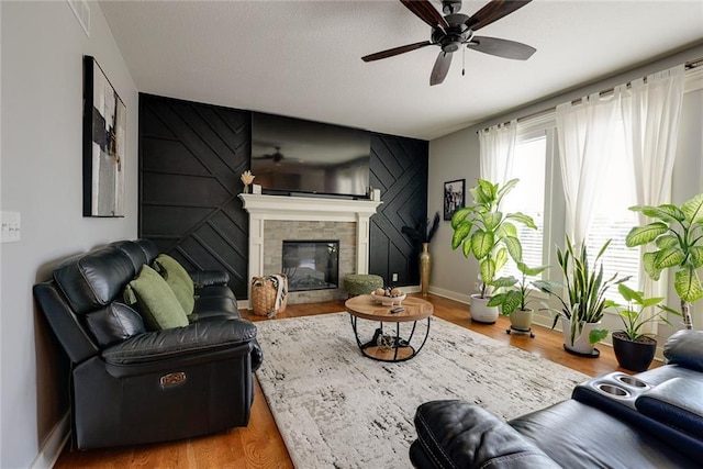 1008 SW Whippoorwill Ln, Oak Grove, MO 64075 - living room featuring a ceiling fan, a glass covered fireplace, and wood finished floors