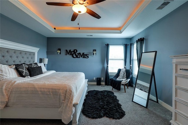 1008 SW Whippoorwill Ln, Oak Grove, MO 64075 - bedroom featuring a tray ceiling, carpet flooring, and ceiling fan