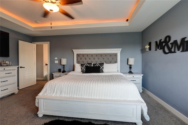 1008 SW Whippoorwill Ln, Oak Grove, MO 64075 - bedroom featuring dark carpet, a tray ceiling, and a ceiling fan