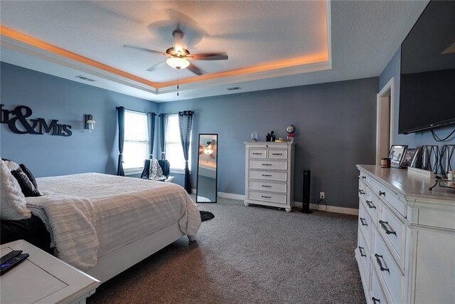 1008 SW Whippoorwill Ln, Oak Grove, MO 64075 - bedroom featuring a tray ceiling, carpet, and ceiling fan