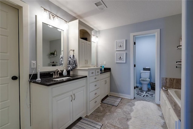1008 SW Whippoorwill Ln, Oak Grove, MO 64075 - bathroom with double vanity, a garden tub, and a textured ceiling