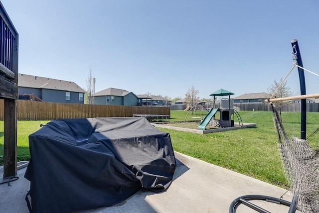 1008 SW Whippoorwill Ln, Oak Grove, MO 64075 - fenced backyard featuring a playground, a trampoline, and a residential view