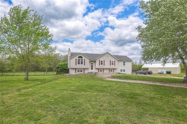 12448 NW Blackwood Dr, Adrian, MO 64720 - bi-level home with fence, a front lawn, and a chimney