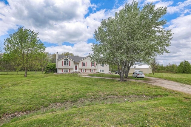 12448 NW Blackwood Dr, Adrian, MO 64720 - view of front of house featuring a chimney, a front lawn, and dirt driveway