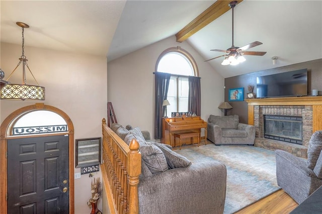 12448 NW Blackwood Dr, Adrian, MO 64720 - living area featuring lofted ceiling with beams, a ceiling fan, wood finished floors, and a fireplace