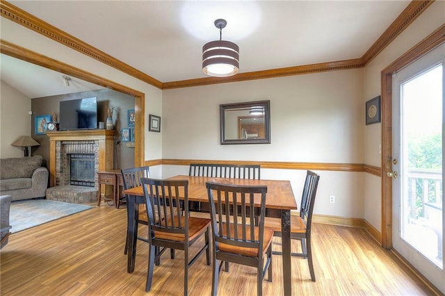 12448 NW Blackwood Dr, Adrian, MO 64720 - dining area with baseboards, crown molding, light wood-style floors, and a fireplace