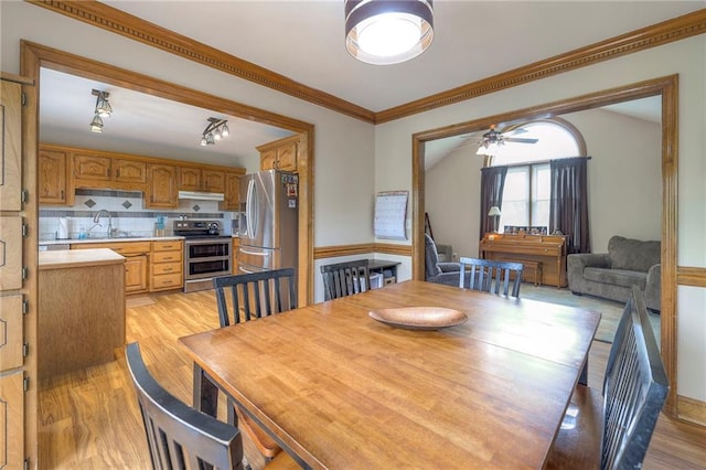 12448 NW Blackwood Dr, Adrian, MO 64720 - dining room featuring light wood-style flooring, crown molding, and ceiling fan