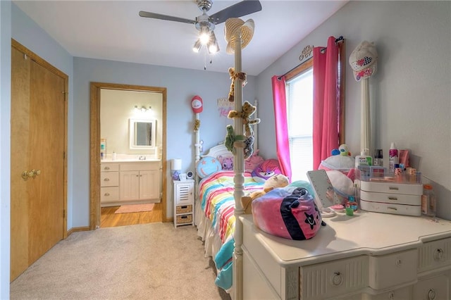 12448 NW Blackwood Dr, Adrian, MO 64720 - bedroom with ensuite bathroom, light colored carpet, and a ceiling fan