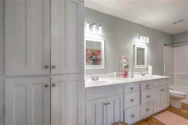 12448 NW Blackwood Dr, Adrian, MO 64720 - bathroom with double vanity, visible vents, toilet, a sink, and shower / tub combination