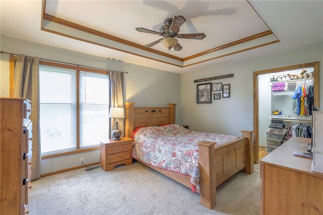 12448 NW Blackwood Dr, Adrian, MO 64720 - bedroom featuring a ceiling fan, light carpet, ornamental molding, and a tray ceiling