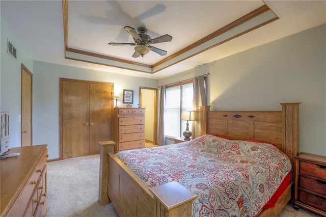 12448 NW Blackwood Dr, Adrian, MO 64720 - bedroom featuring a ceiling fan, a closet, a tray ceiling, light colored carpet, and visible vents