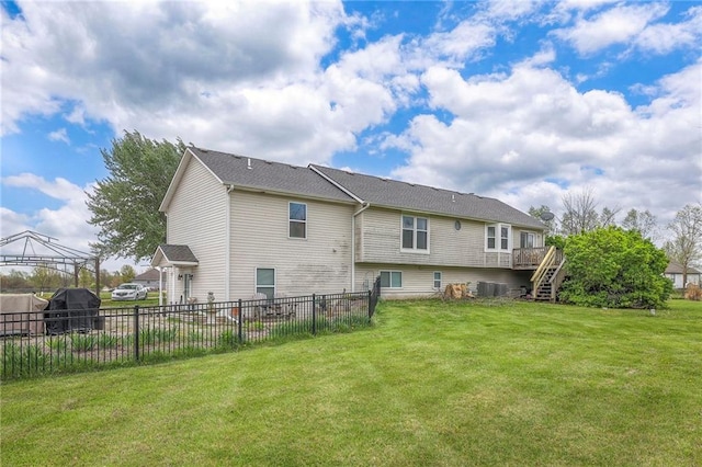 12448 NW Blackwood Dr, Adrian, MO 64720 - rear view of property featuring stairway, fence, a yard, cooling unit, and a deck