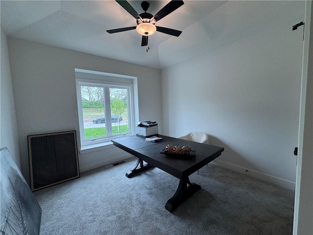 carpeted office with baseboards, visible vents, and ceiling fan