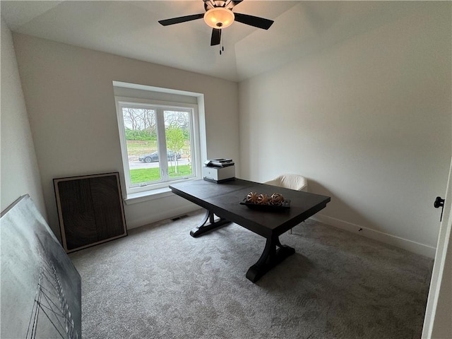office area with baseboards, visible vents, a ceiling fan, and carpet flooring