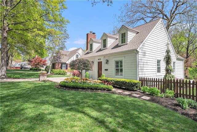 cape cod house featuring fence, a chimney, roof with shingles, and a front lawn
