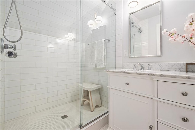 bathroom with vanity and tiled shower