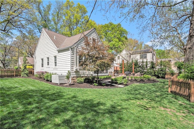 view of property exterior with fence, a shingled roof, a lawn, and central AC