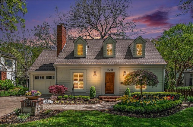 cape cod house with concrete driveway, a chimney, roof with shingles, and a garage