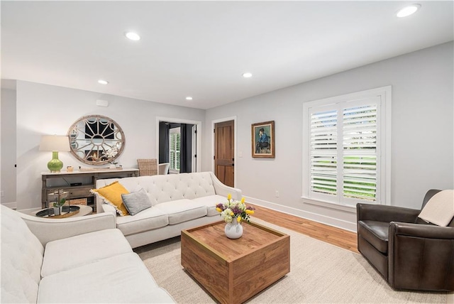 living room featuring light wood finished floors, recessed lighting, and a wealth of natural light