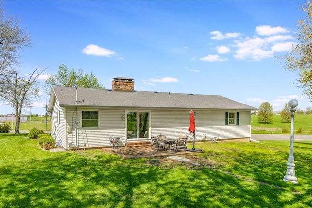 2931 N Washington St, Chillicothe, MO 64601 - back of house with a lawn, a patio area, and a chimney