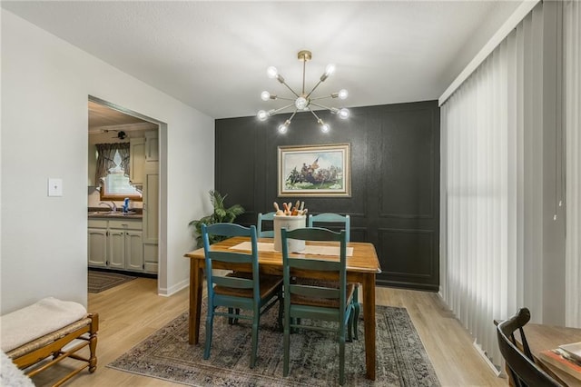 2931 N Washington St, Chillicothe, MO 64601 - dining room with an inviting chandelier, light wood-style floors, and a decorative wall