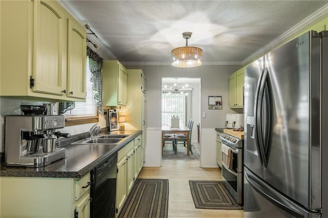 2931 N Washington St, Chillicothe, MO 64601 - kitchen with stainless steel appliances, a sink, light wood-style floors, a chandelier, and crown molding