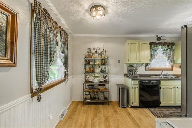 2931 N Washington St, Chillicothe, MO 64601 - kitchen with light wood finished floors, a wainscoted wall, visible vents, black dishwasher, and green cabinets