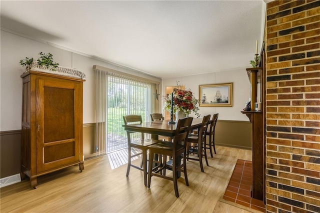 2931 N Washington St, Chillicothe, MO 64601 - dining space featuring light wood-type flooring, wainscoting, and ornamental molding