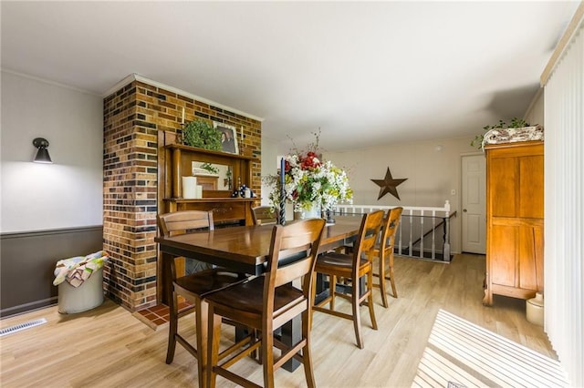2931 N Washington St, Chillicothe, MO 64601 - dining area featuring visible vents, light wood-style floors, and ornamental molding