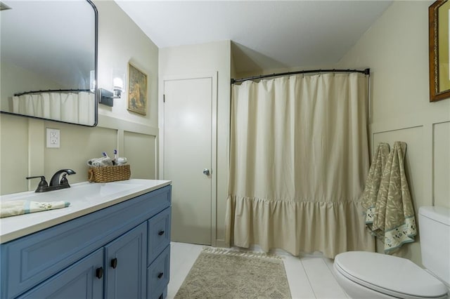 2931 N Washington St, Chillicothe, MO 64601 - bathroom featuring curtained shower, vanity, tile patterned flooring, and toilet