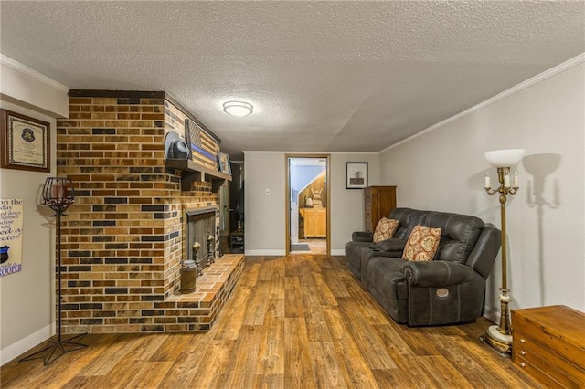 2931 N Washington St, Chillicothe, MO 64601 - living room featuring a textured ceiling, crown molding, baseboards, a brick fireplace, and hardwood / wood-style flooring