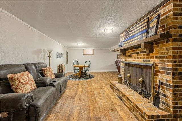 2931 N Washington St, Chillicothe, MO 64601 - living area with a textured ceiling, wood finished floors, a brick fireplace, and baseboards