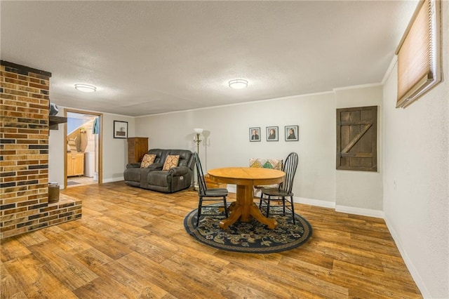 2931 N Washington St, Chillicothe, MO 64601 - dining space with baseboards, wood finished floors, and a textured ceiling