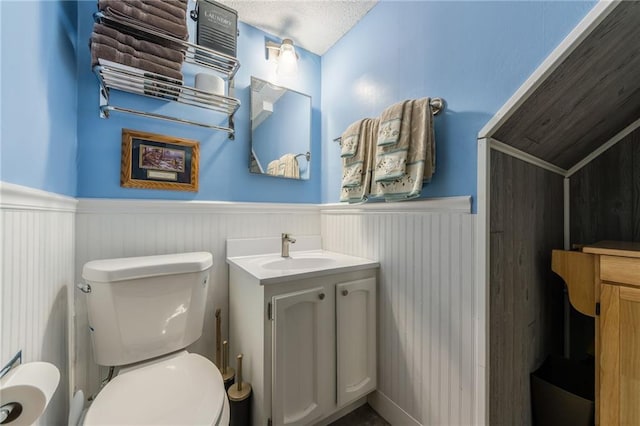 2931 N Washington St, Chillicothe, MO 64601 - bathroom with wainscoting, vanity, and toilet