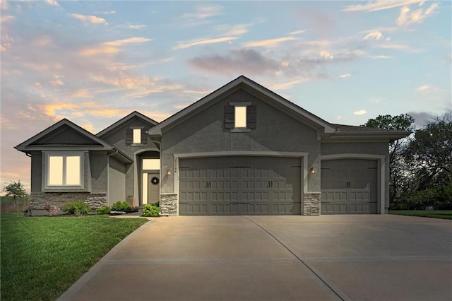 view of front of property with a garage, driveway, a front lawn, and stone siding