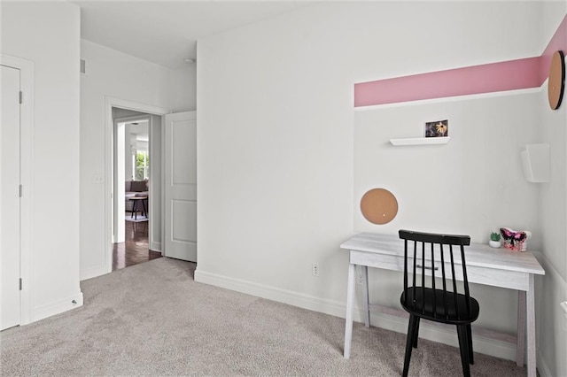 carpeted home office featuring baseboards