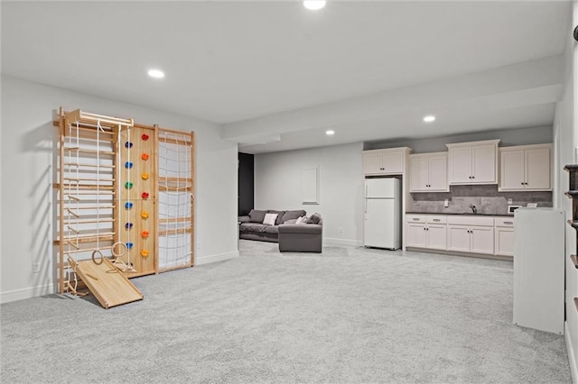 living room with recessed lighting, baseboards, and light carpet
