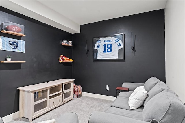 living area featuring baseboards and carpet