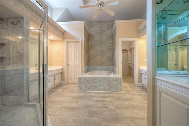 full bath with a walk in closet, vanity, a ceiling fan, a shower stall, and a bath