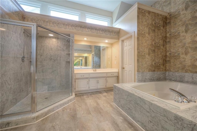 full bathroom featuring vanity, a bath, and a shower stall