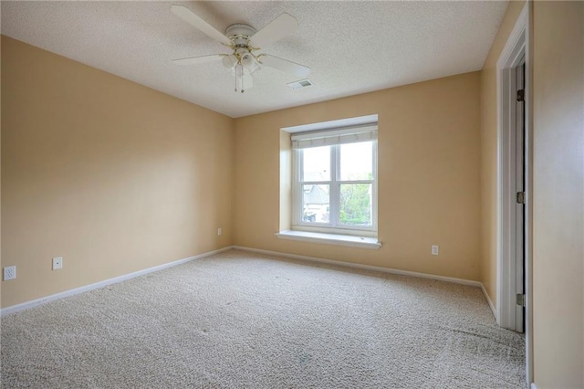 unfurnished room featuring light carpet, a textured ceiling, and visible vents